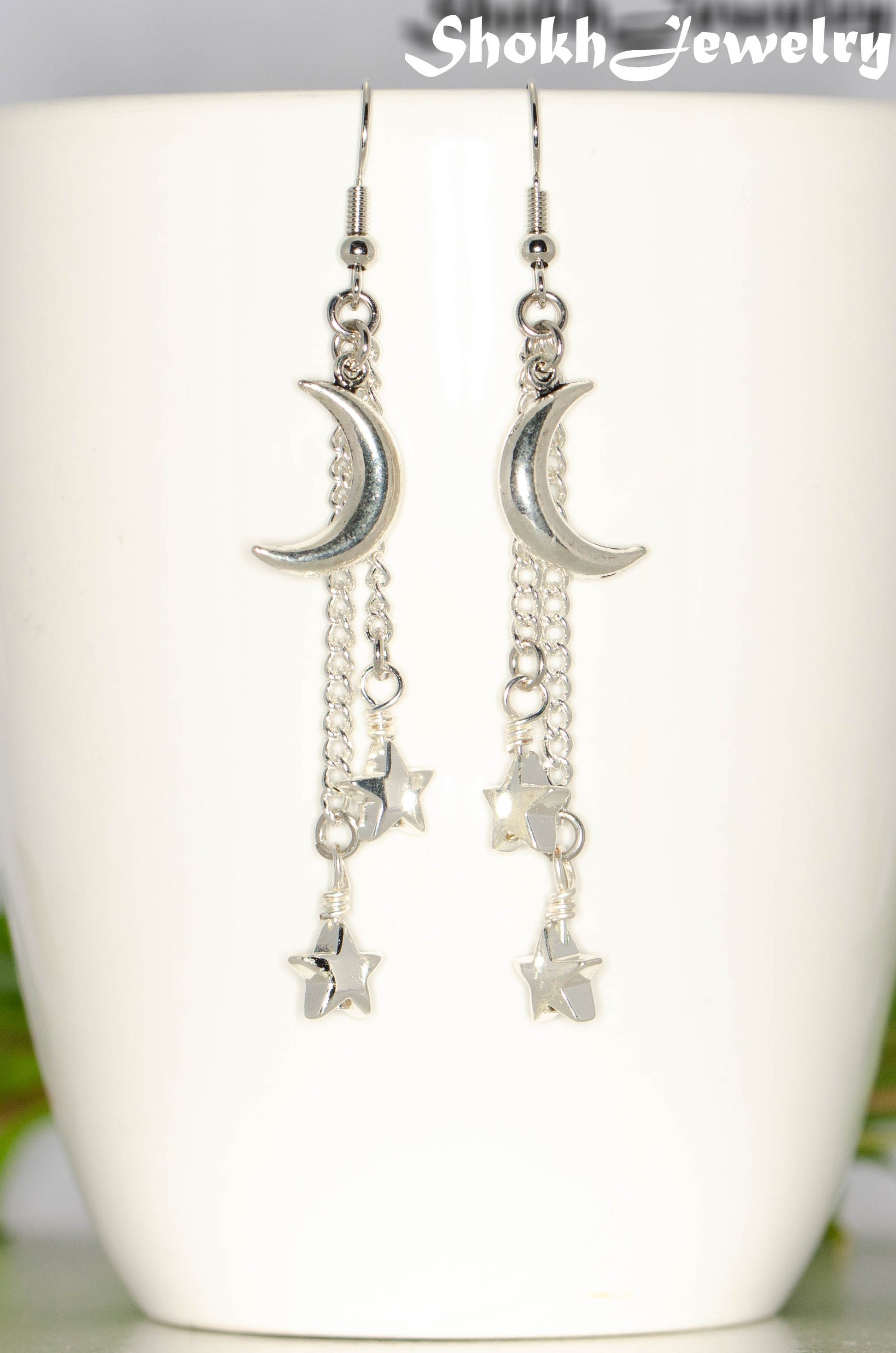 Close up of Long Crescent Moon and Hematite Star Earrings.