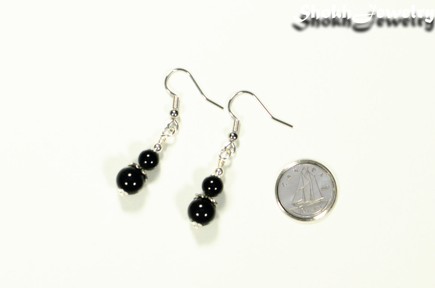 Small Black Tourmaline Earrings beside a dime.