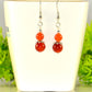 Small Natural Fire Agate Earrings displayed on a tea cup.