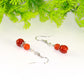 Close up of Small Natural Fire Agate Earrings.
