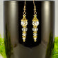 Sparkly Crystal Clear Glass Bead Earrings displayed on a coffee mug.