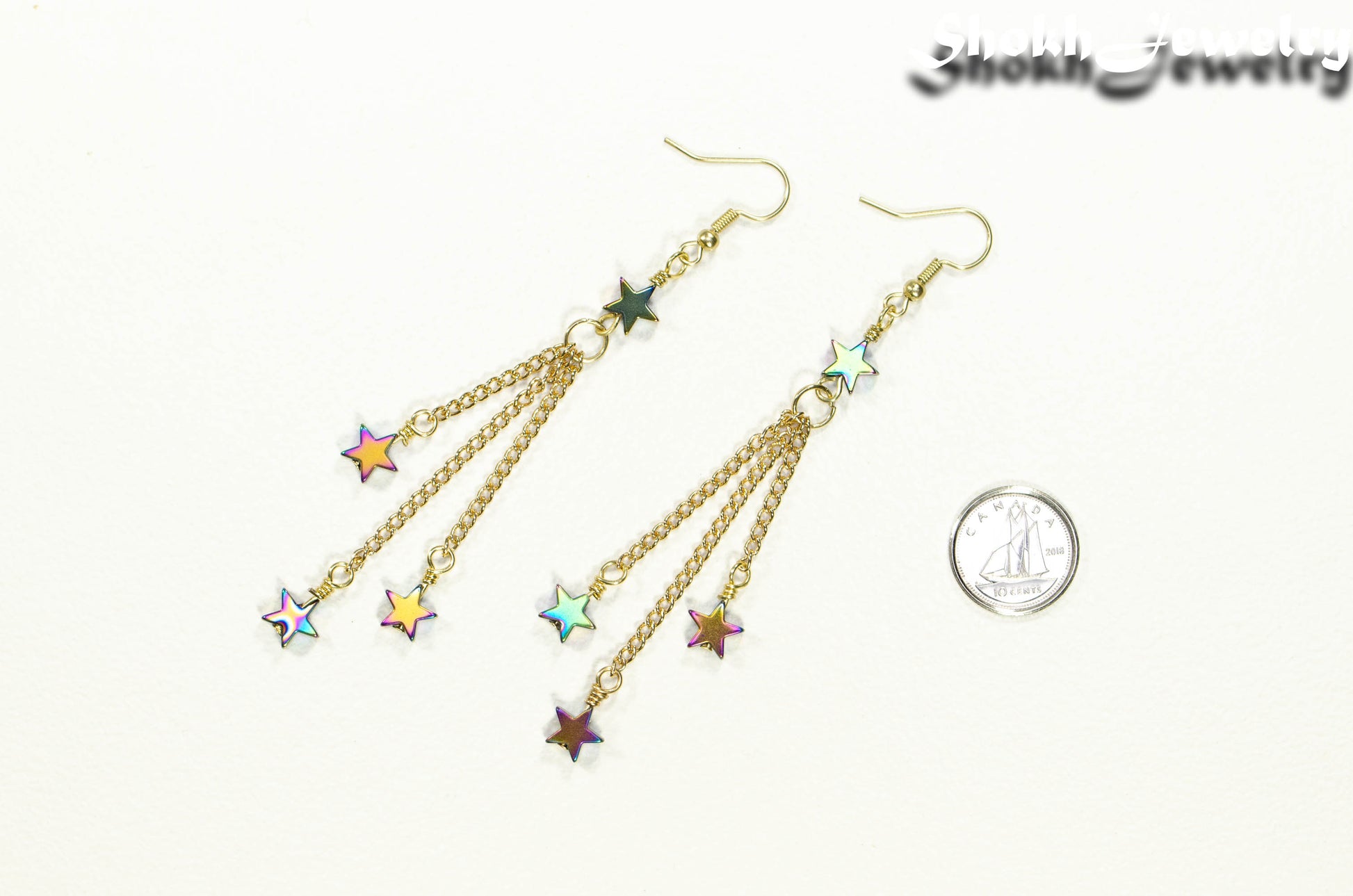 Sparkly Hematite Star and Gold Chain Earrings beside a dime.