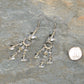 Statement Clear Quartz Chandelier Earrings beside a dime.