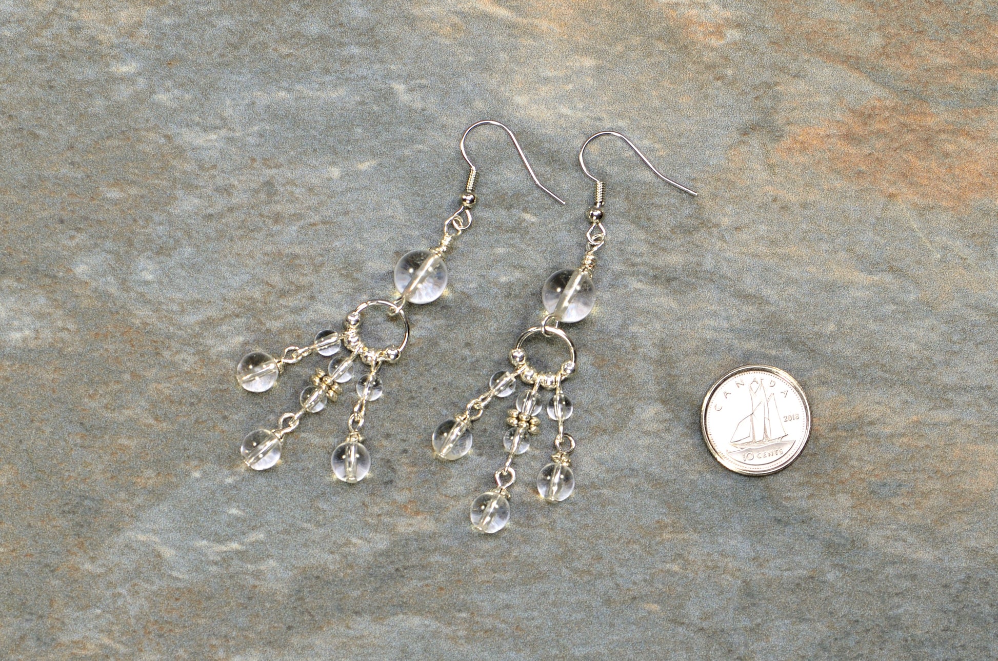 Statement Clear Quartz Chandelier Earrings beside a dime.