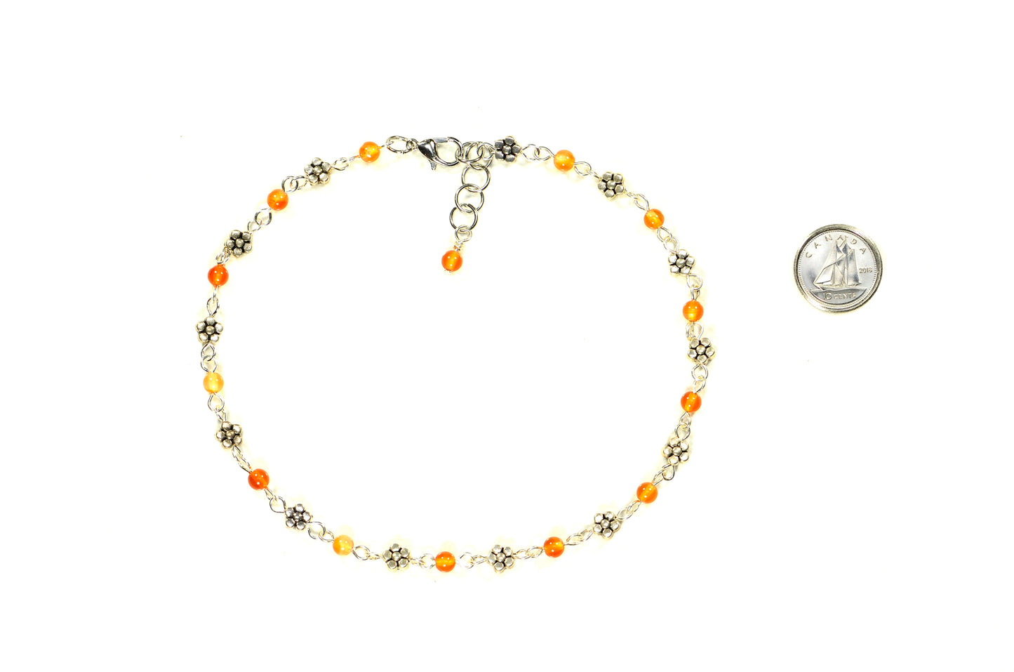 Tibetan Silver Flower and Carnelian Choker Necklace beside a dime.