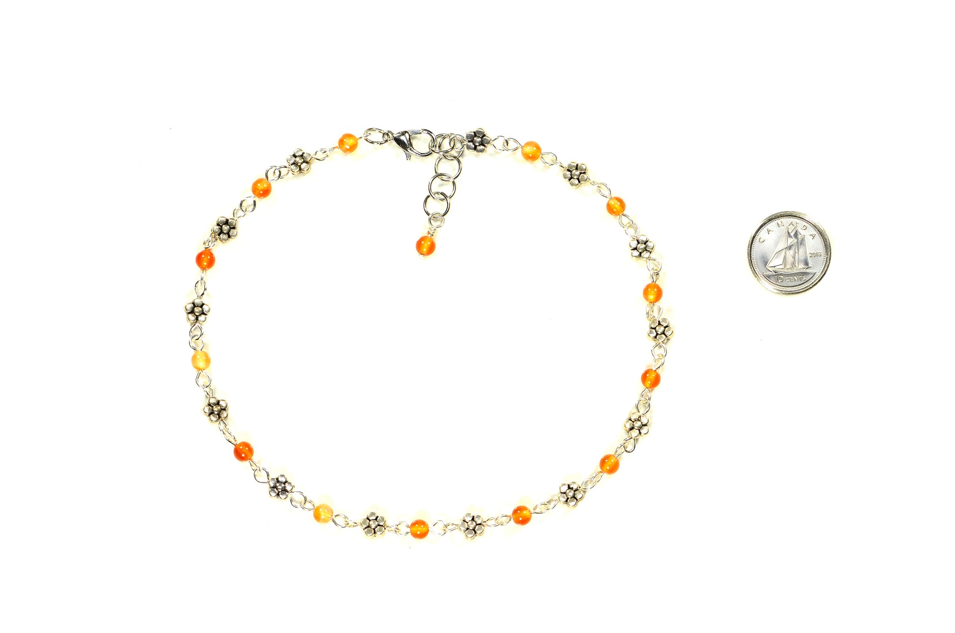Tibetan Silver Flower and Carnelian Choker Necklace beside a dime.