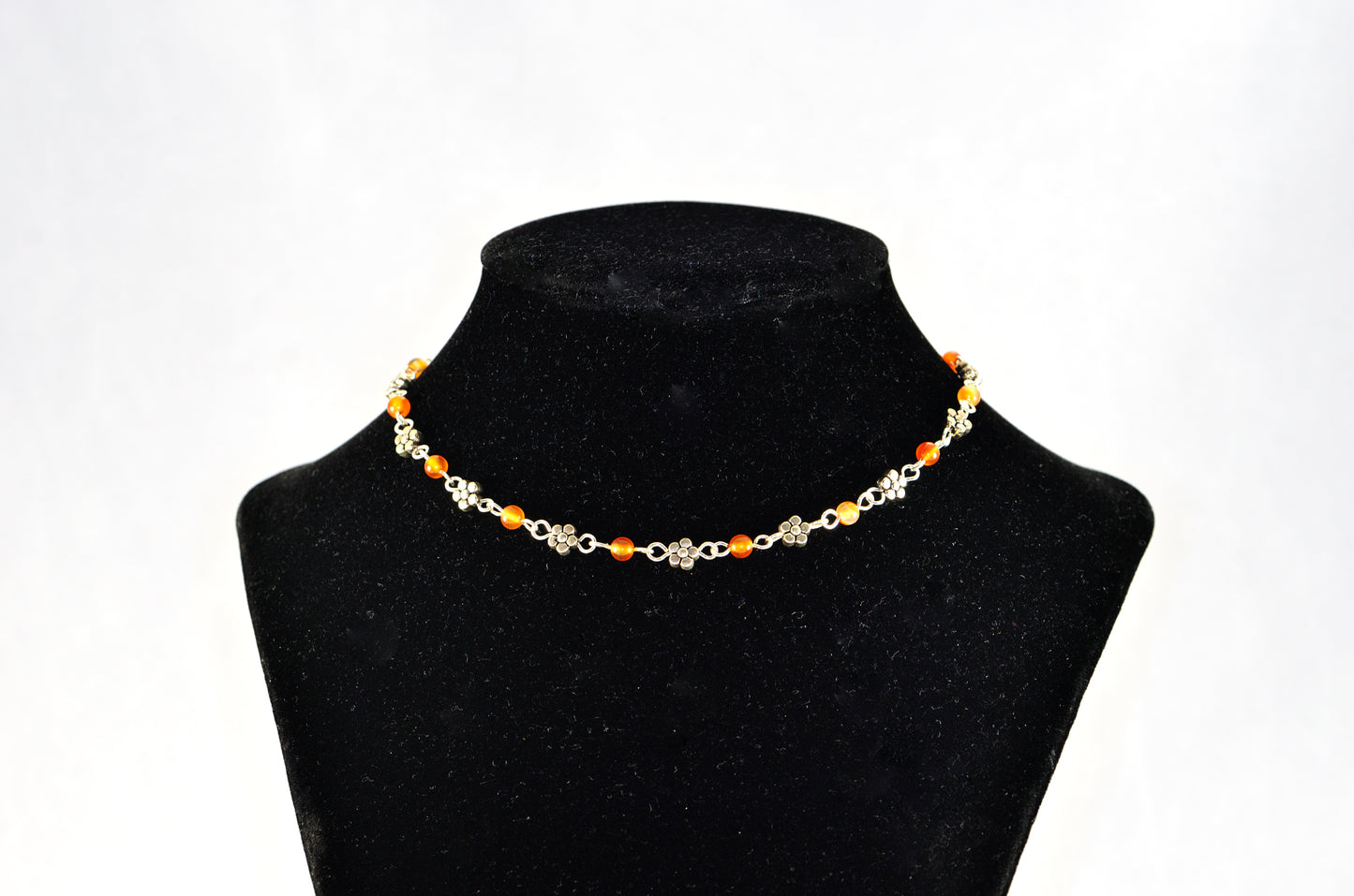 Tibetan Silver Flower and Carnelian Choker Necklace displayed on a bust.