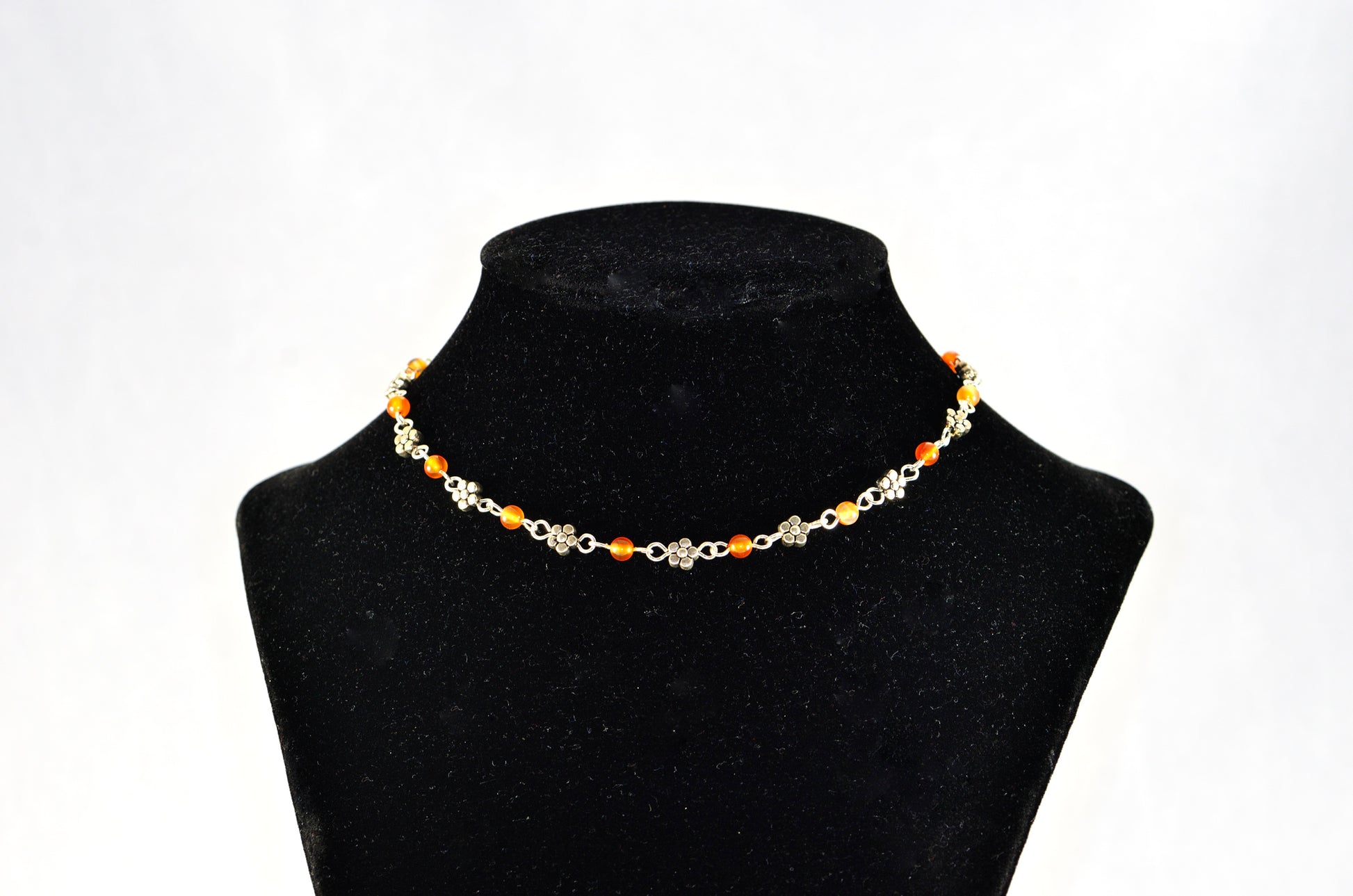 Tibetan Silver Flower and Carnelian Choker Necklace displayed on a bust.