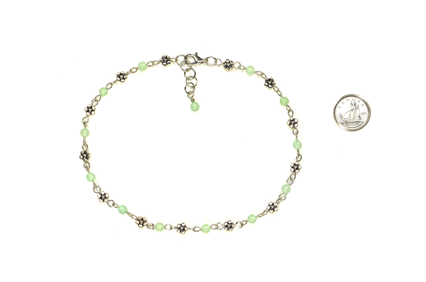 Tibetan Silver Flower and Green Aventurine Choker Necklace beside a dime.