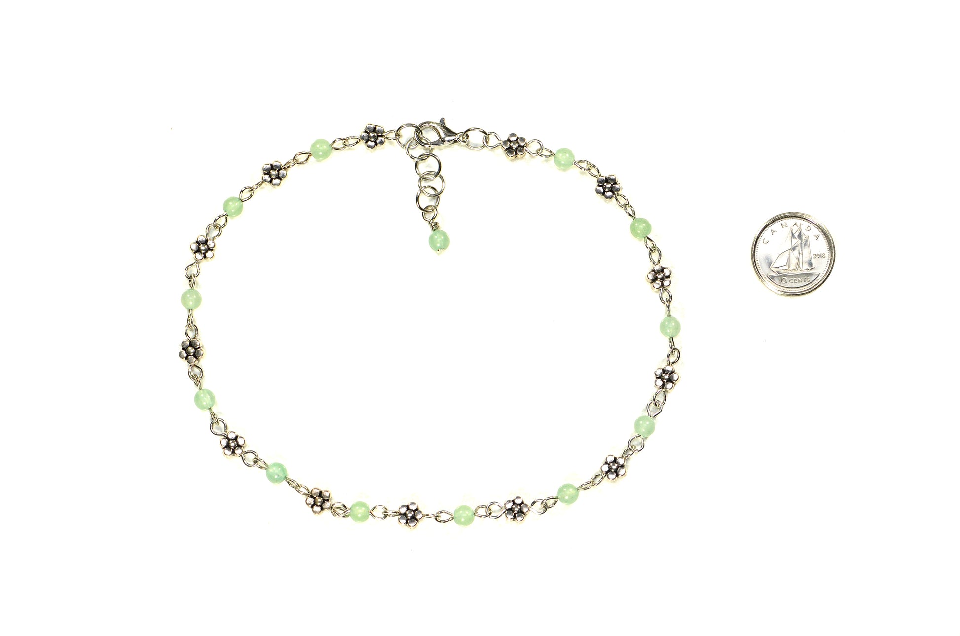 Tibetan Silver Flower and Green Aventurine Choker Necklace beside a dime.