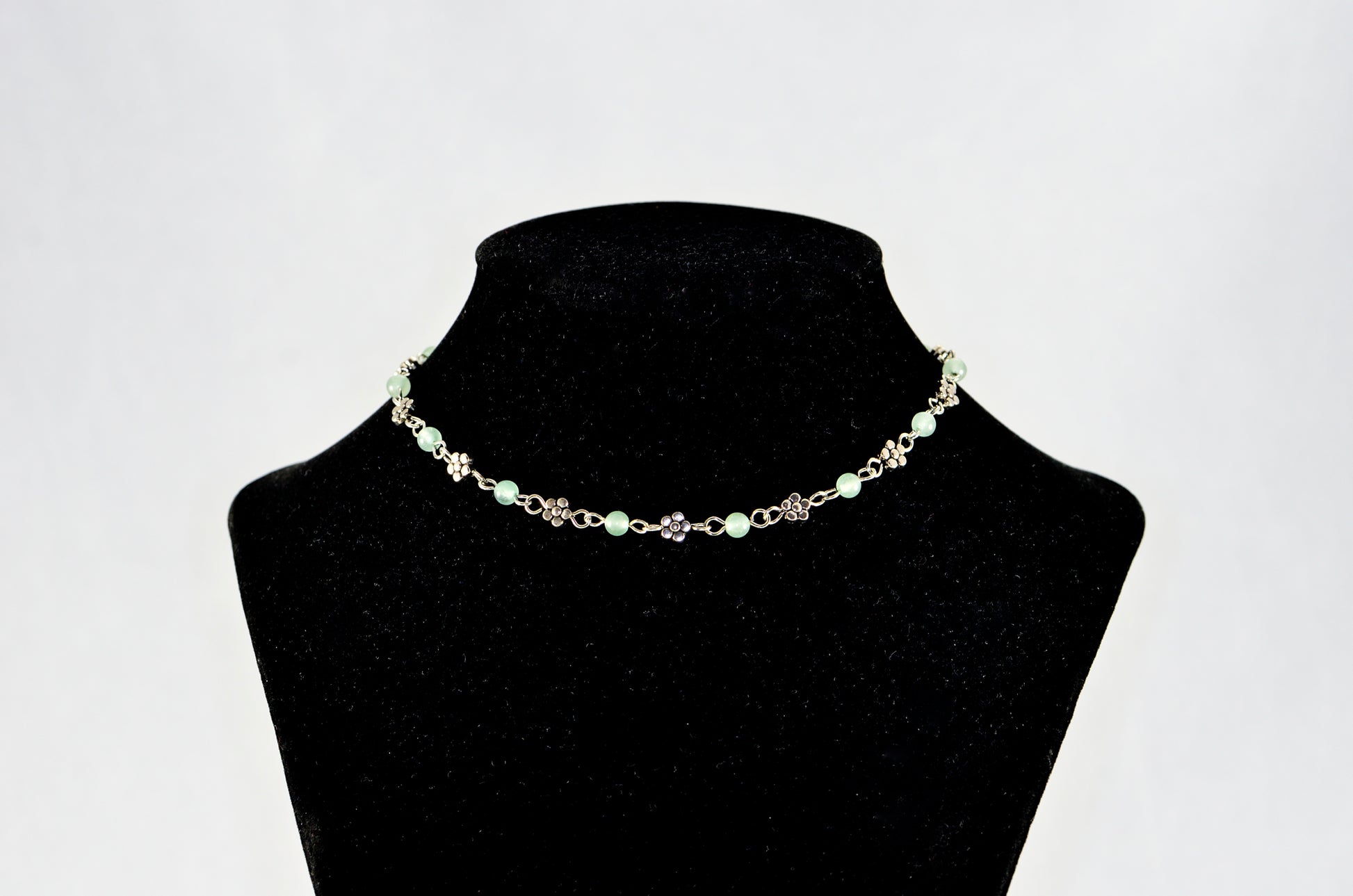 Tibetan Silver Flower and Green Aventurine Choker Necklace displayed on a bust.
