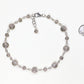 Tibetan Silver Star Sun and Moon Choker Necklace beside a dime.