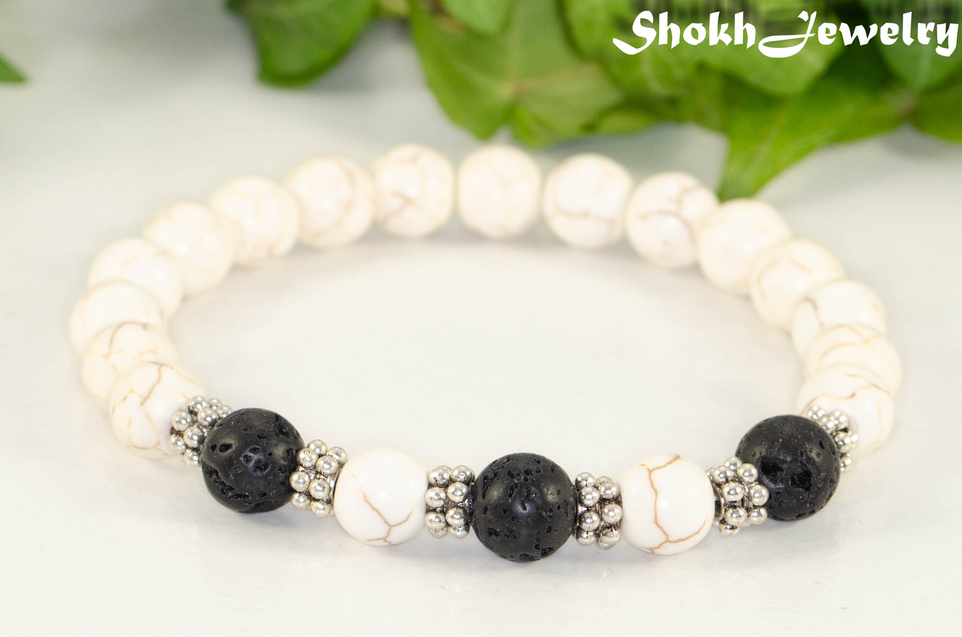Close up of White Howlite and Black Lava Stone Bracelet.