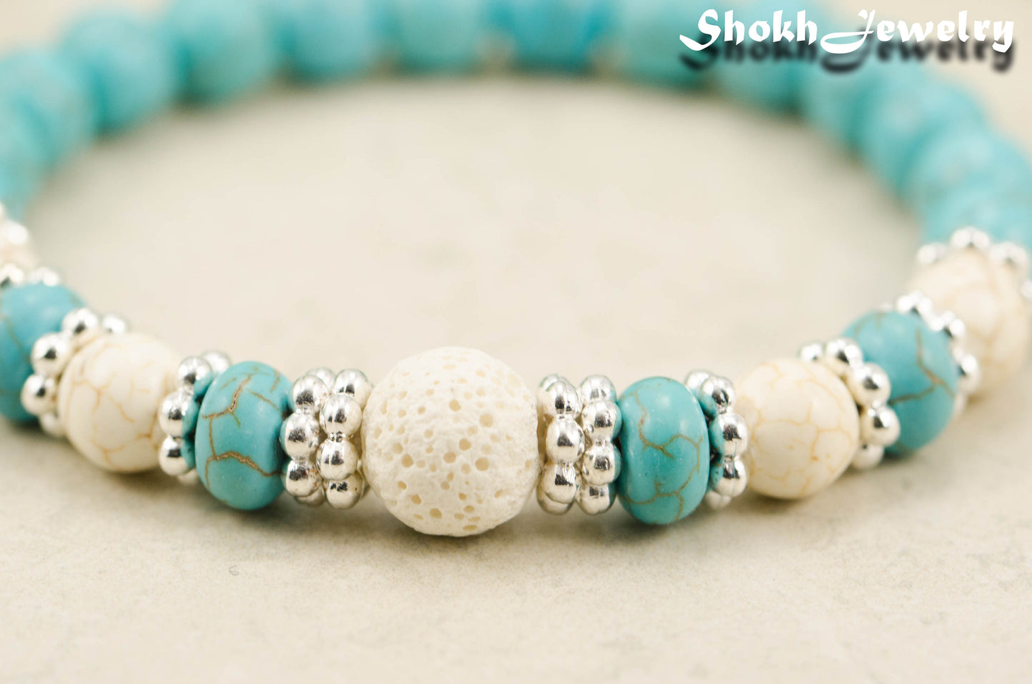 Close up of Turquoise Howlite and Lava Stone Bracelet with white howlite accent beads.