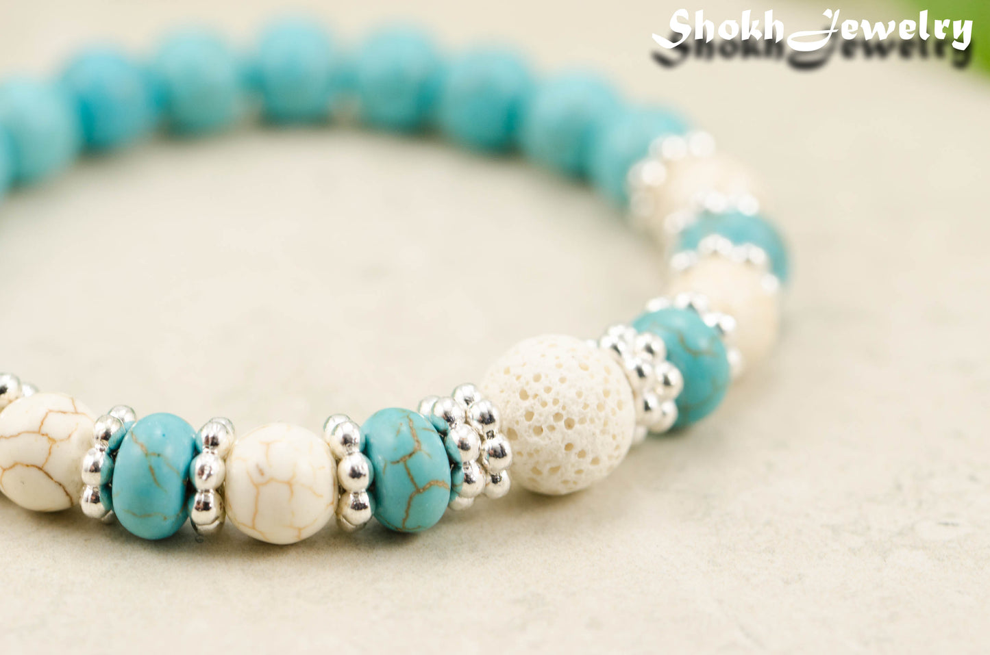 Close up of Turquoise Howlite and Lava Stone Bracelet with white howlite accent beads.