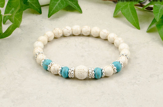 White Howlite and Lava Stone Bracelet with turquoise howlite accent beads.