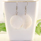 25mm White Seashell Earrings displayed on a tea cup.