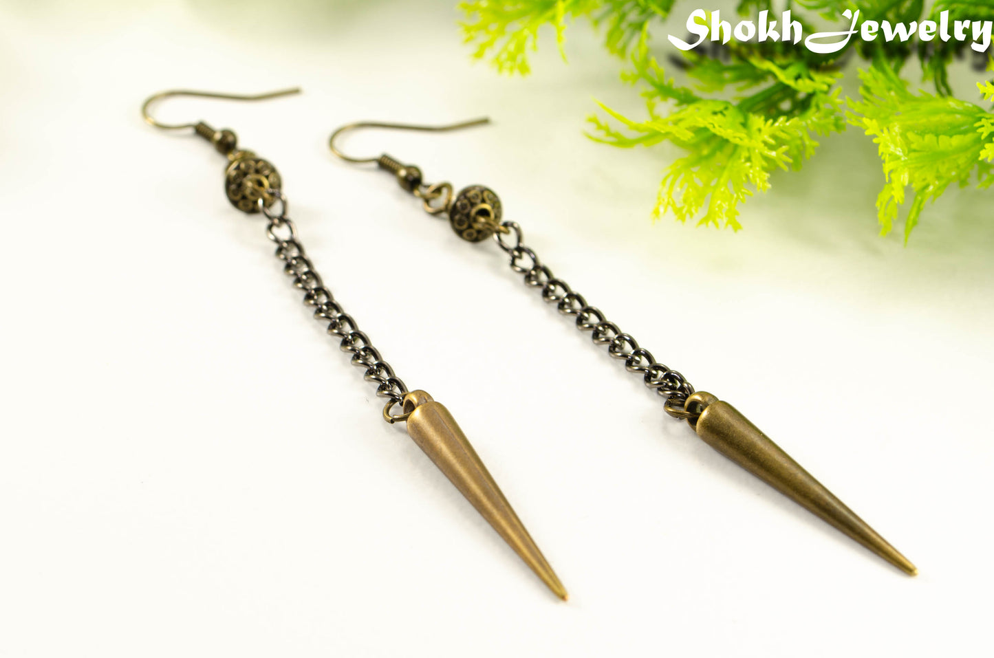 Close up of Statement chain and antique bronze spike earrings