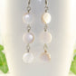 Close up of Long White Natural Seashell Earrings.