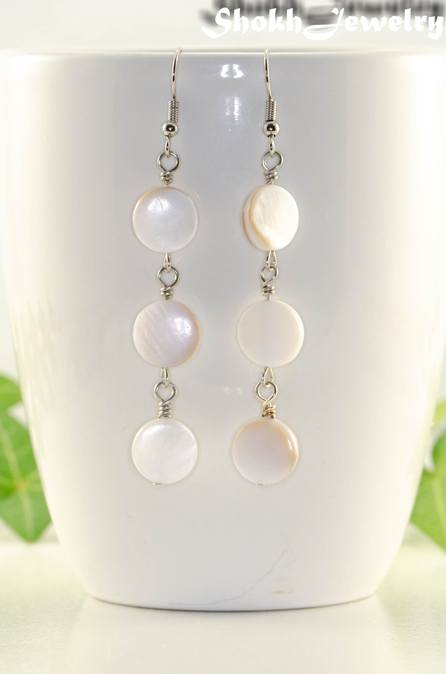 Close up of Long White Natural Seashell Earrings.