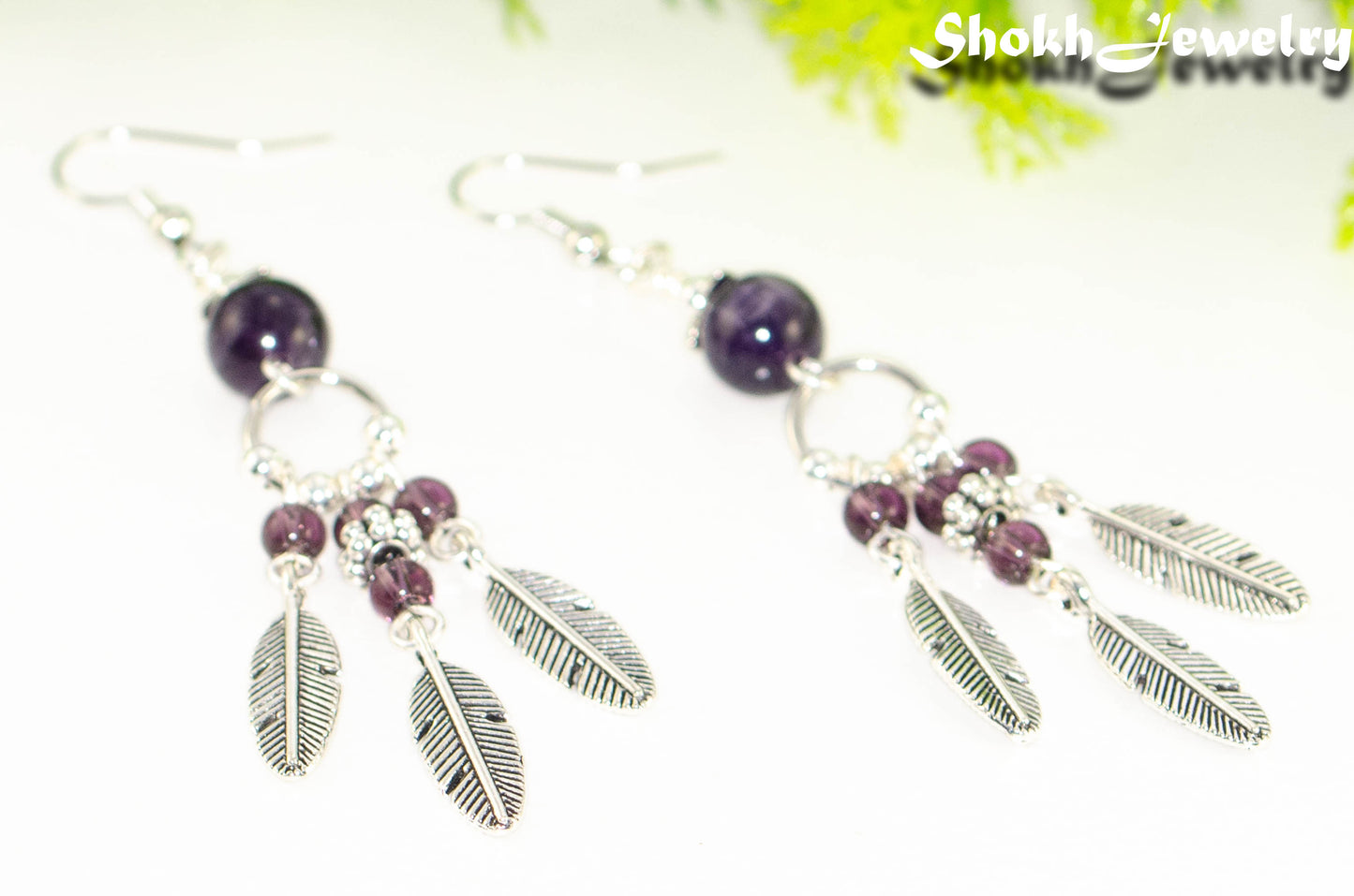 Close up of Statement Amethyst Crystal And Feather Earrings.