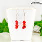 Natural Red Coral Chip Earrings displayed on a tea cup