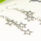 Close up of Stainless steel chain and star earrings