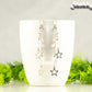 Clear Glass and Stainless Steel Star Earrings displayed on a white coffee mug.