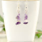 Simple Amethyst Crystal Chip Earrings displayed on a tea cup.