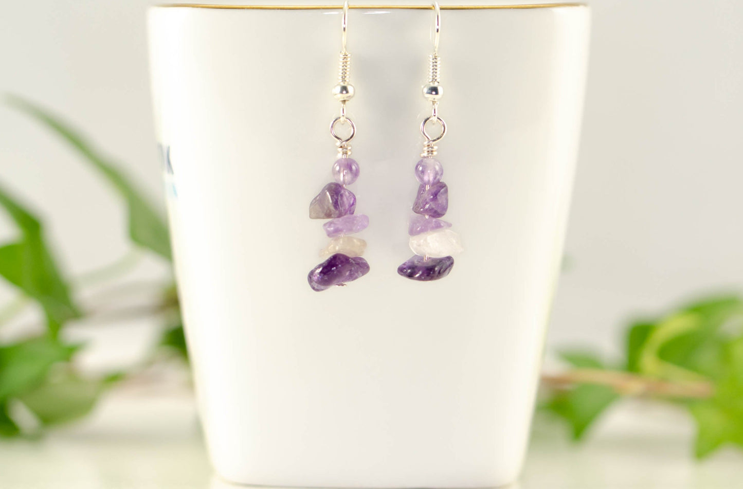 Simple Amethyst Crystal Chip Earrings displayed on a tea cup.