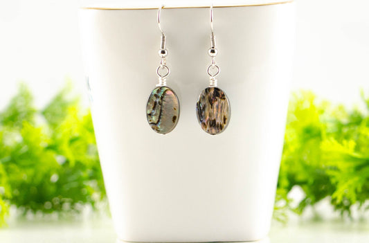 Simple Oval Abalone Shell Earrings displayed on a tea cup.