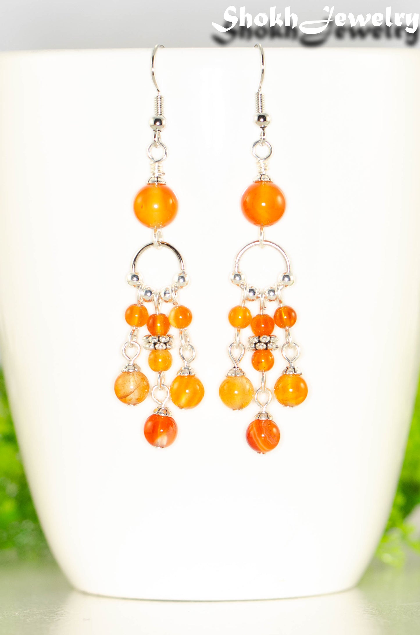 Close up of Statement Carnelian Crystal Chandelier Earrings.