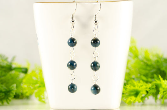 Dark Blue Natural Seashell Earrings displayed on a tea cup.