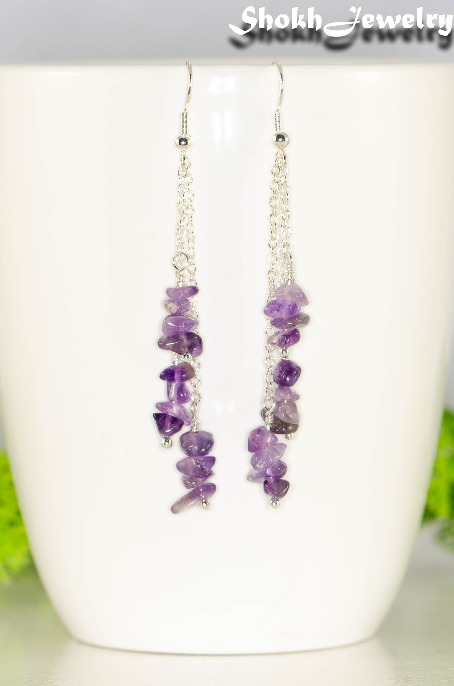 Long Silver Plated Chain and Amethyst Crystal Chip Earrings on a mug