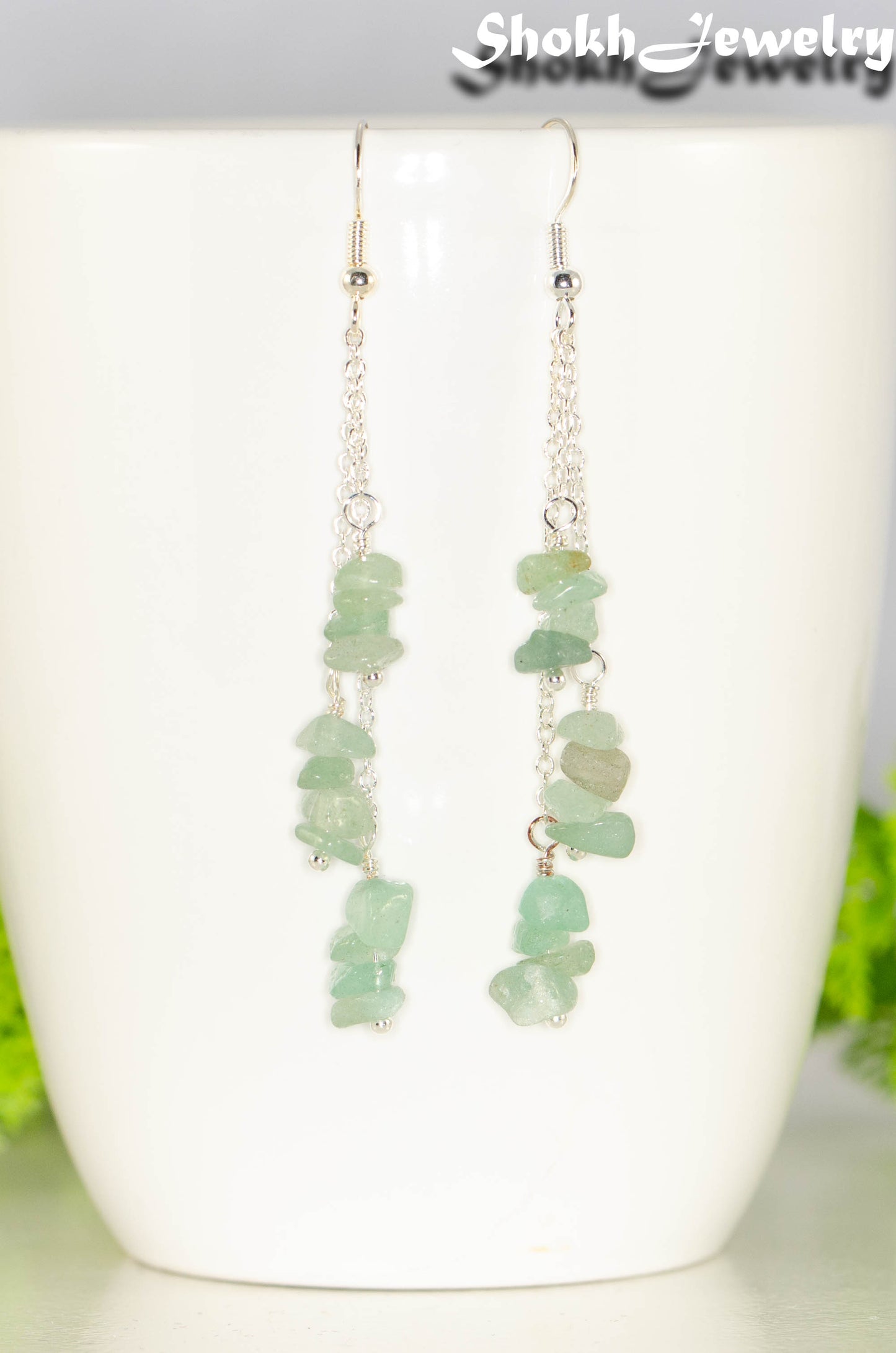 Long Silver Plated Chain and Green Aventurine Crystal Chip Earrings on a mug