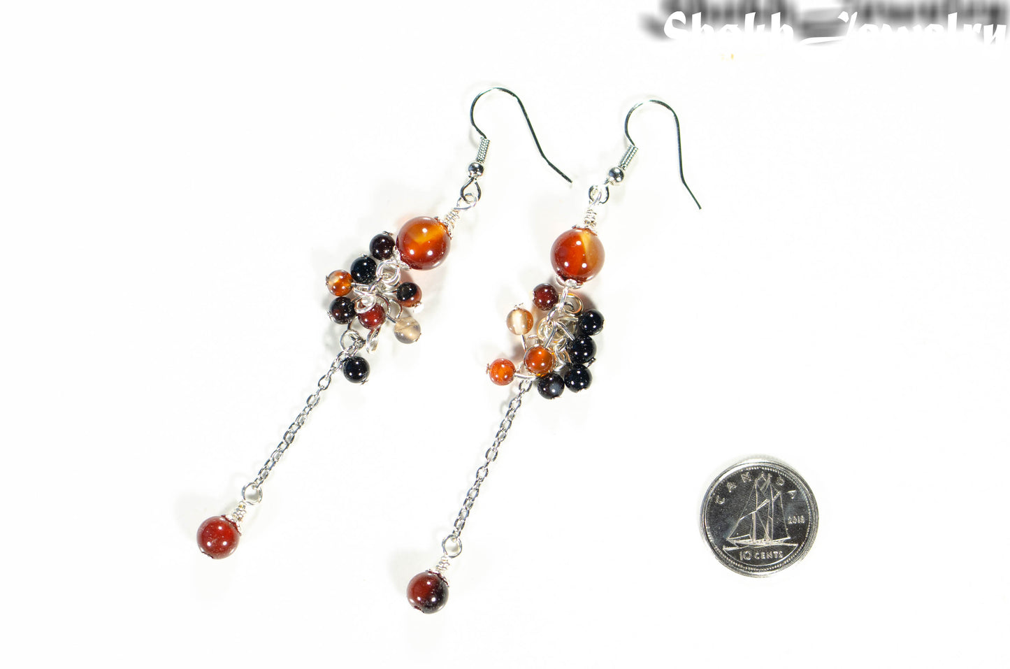 Long Stainless Steel Chain and Carnelian Earrings beside a dime.