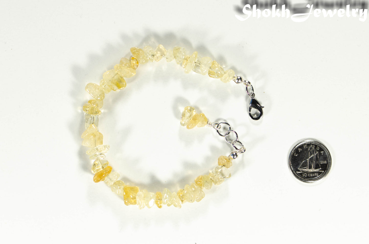 Natural Citrine Crystal Chip Bracelet beside a dime