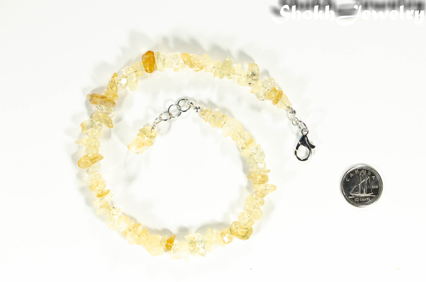 Natural Raw Citrine Crystal Chip Anklet beside a dime