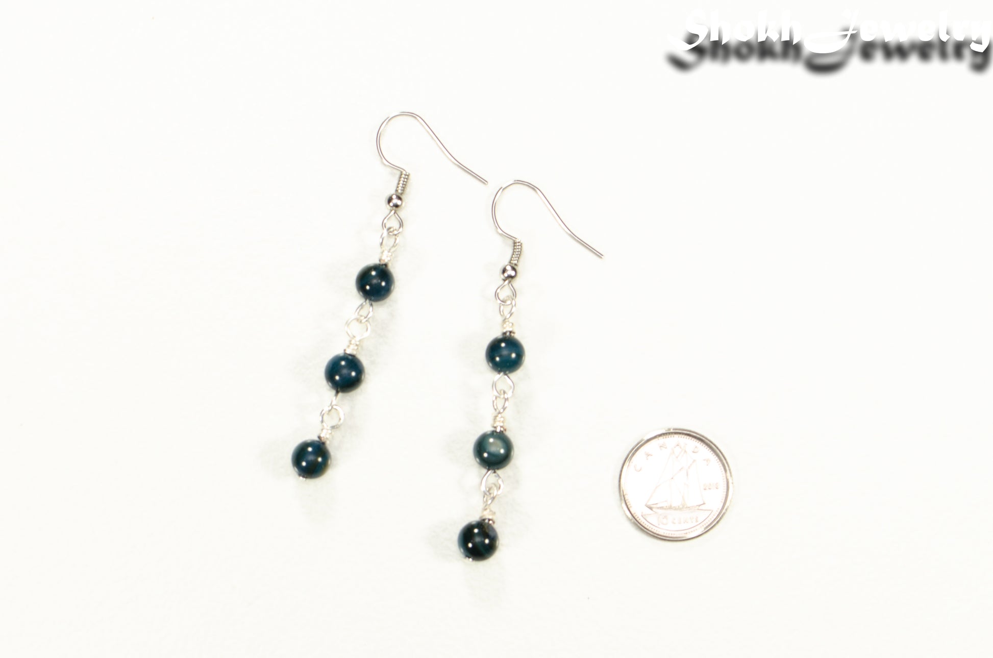 Dark Blue Natural Seashell Earrings beside a dime.