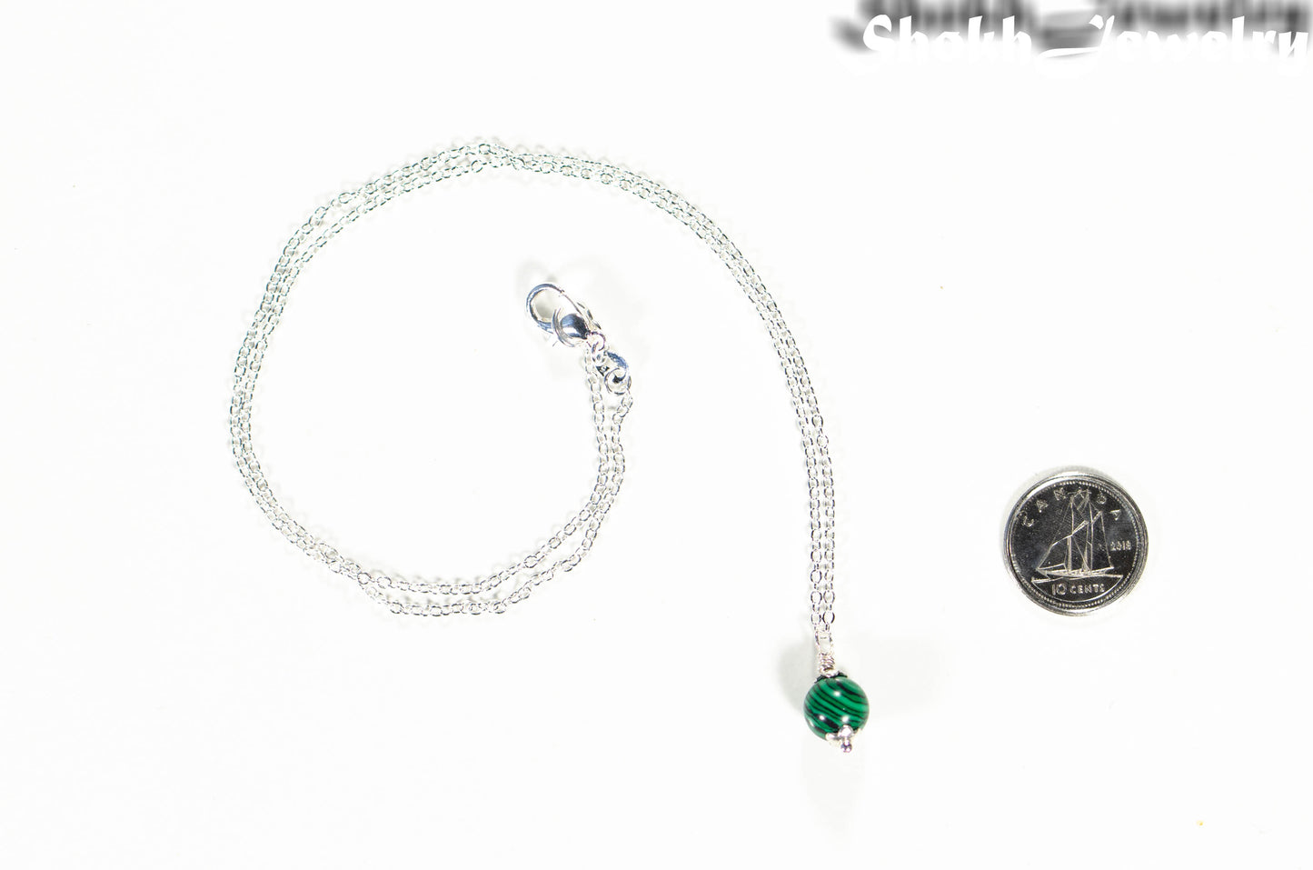 Dainty Malachite Choker Necklace beside a dime