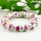 12mm Ceramic Pink Flower Bracelet with rhinestone spacer beads.