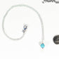 Dainty Turquoise Howlite Choker Necklace beside a dime