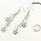 Clear Glass and Stainless Steel Star Earrings beside a dime.