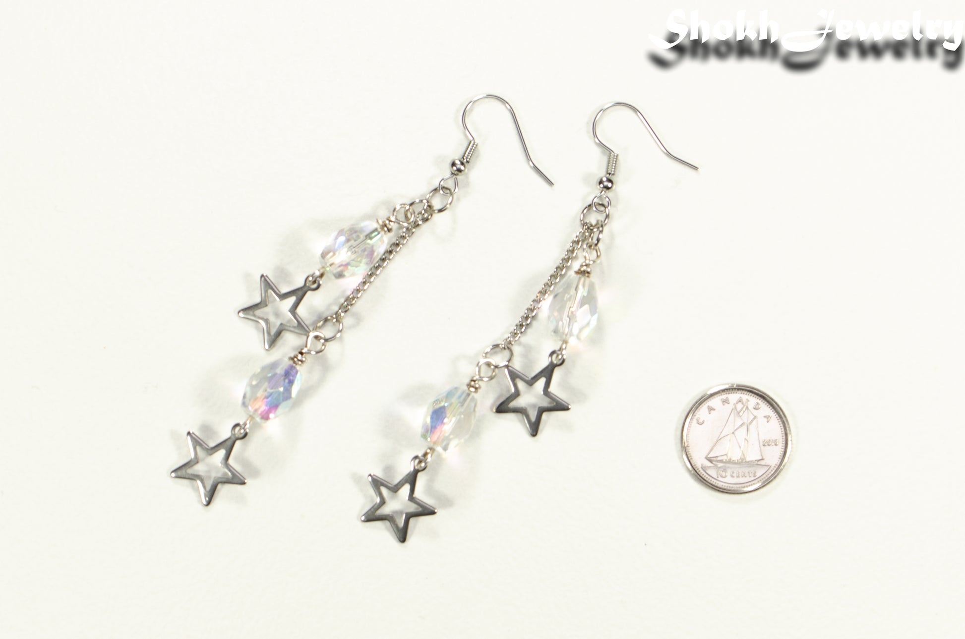 Clear Glass and Stainless Steel Star Earrings beside a dime.