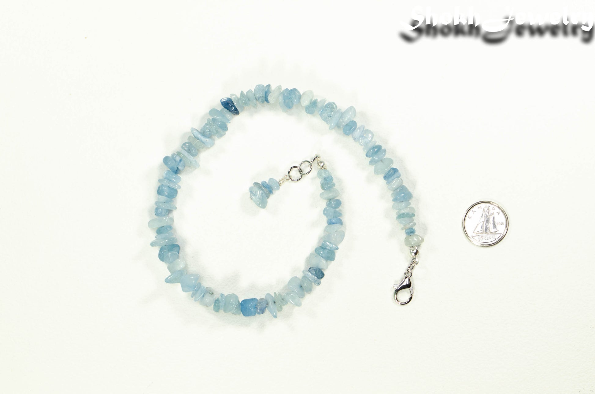 Natural Aquamarine Crystal Chip Choker Necklace beside a dime