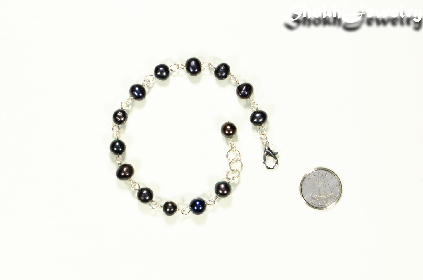 Handmade Black Freshwater Pearls Link Chain Bracelet beside a dime