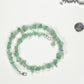 Natural Green Aventurine Crystal Chip Choker Necklace beside a dime