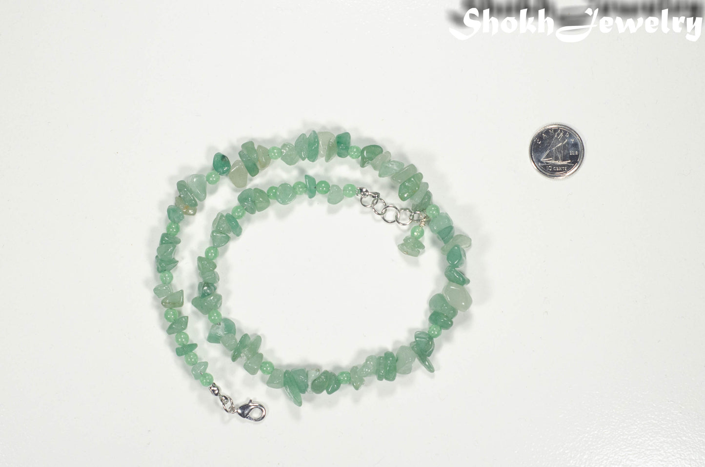 Natural Green Aventurine Crystal Chip Choker Necklace beside a dime