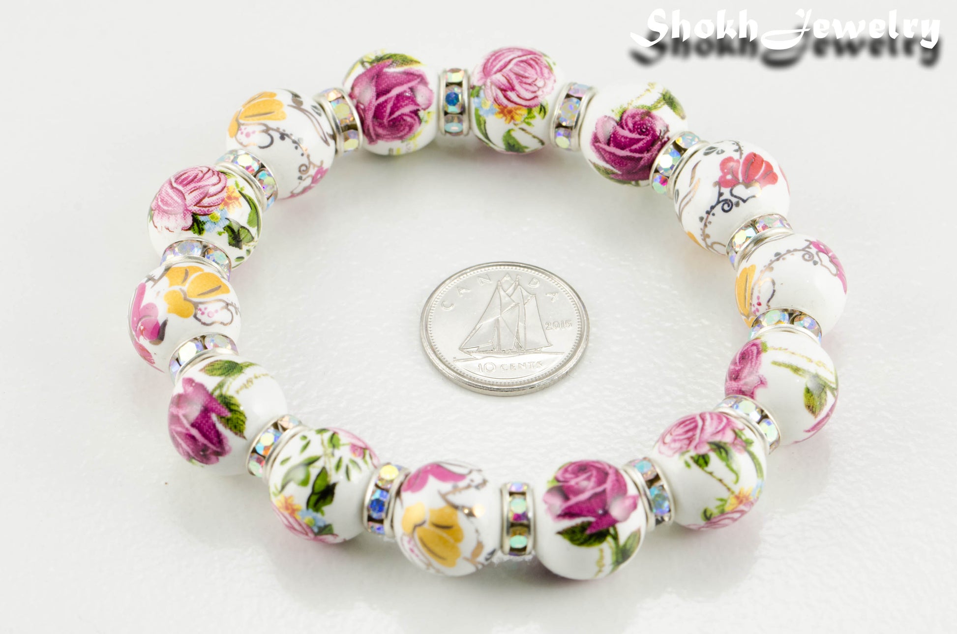 12mm Ceramic Pink Flower Bracelet beside a dime.