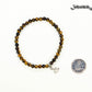 4mm Tiger's Eye Bracelet with Initial beside a dime.